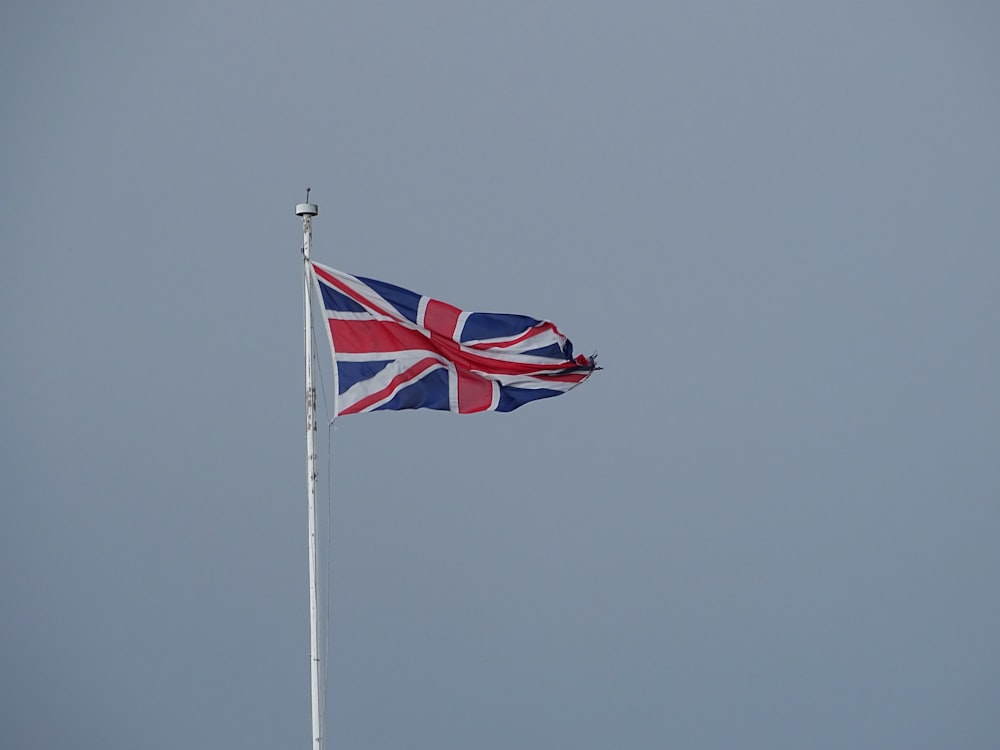 red white and blue flag on pole during daytime