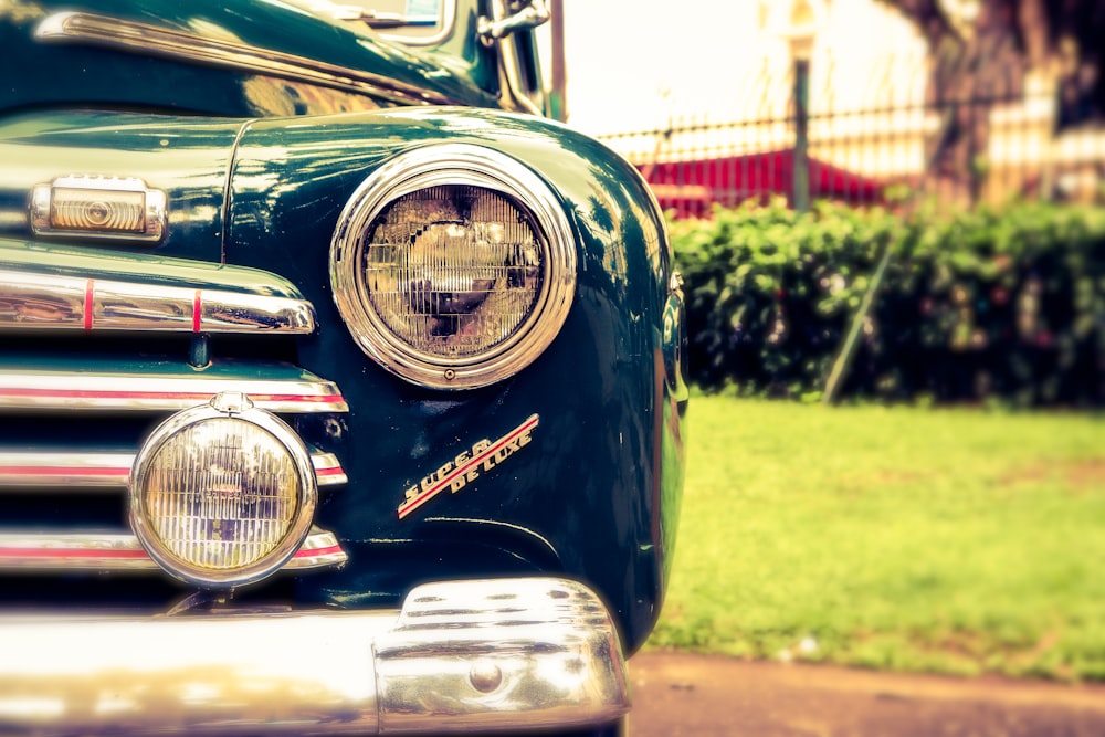 black vintage car on green grass field during daytime