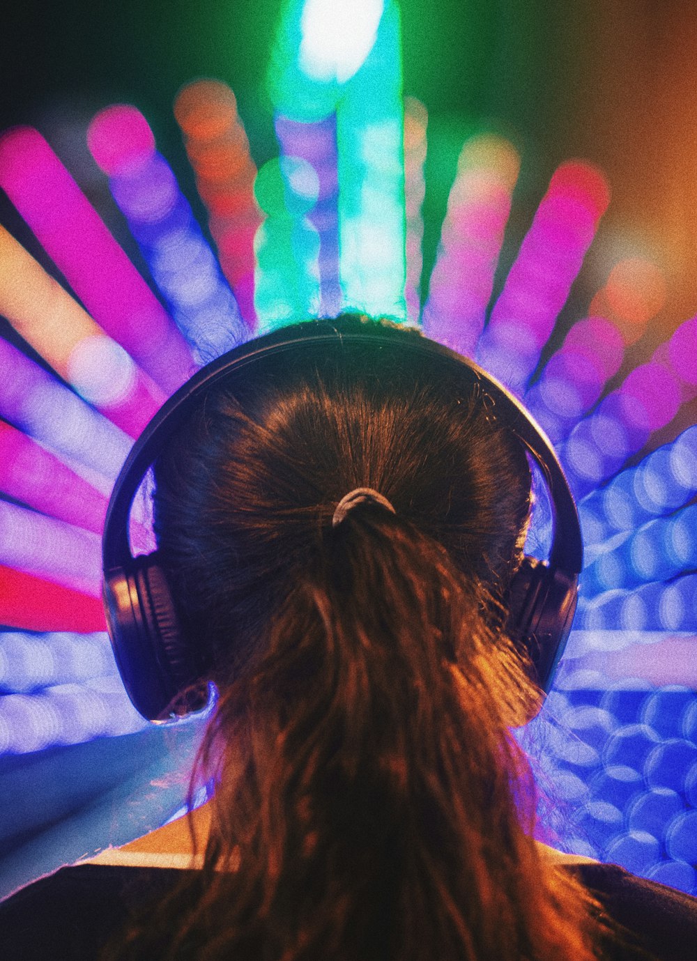 woman in white shirt wearing black headphones