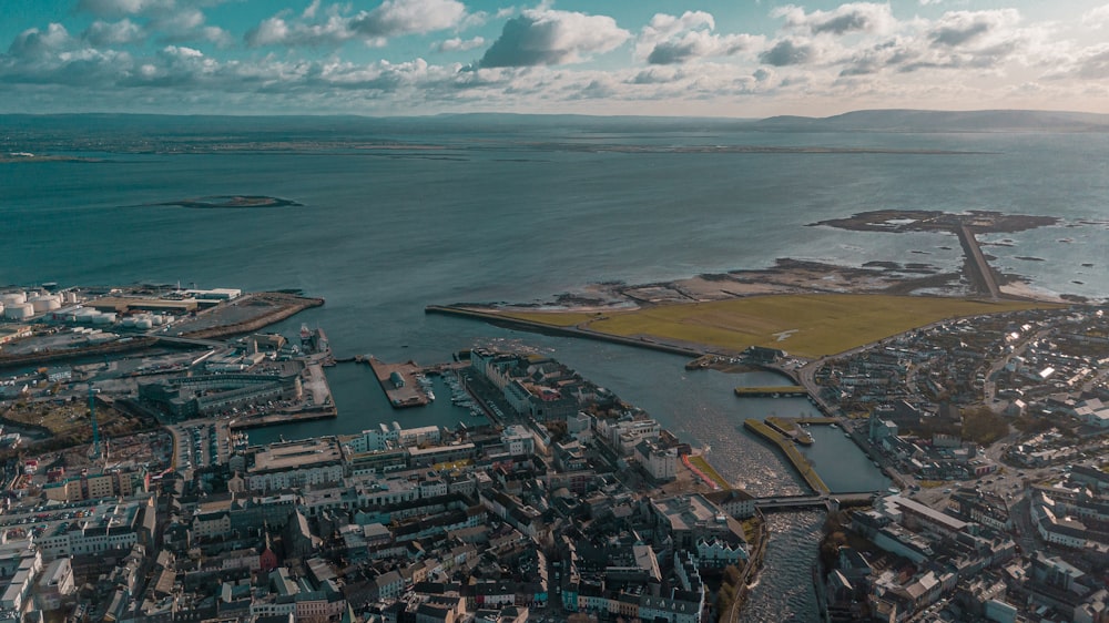 aerial view of city buildings near sea during daytime