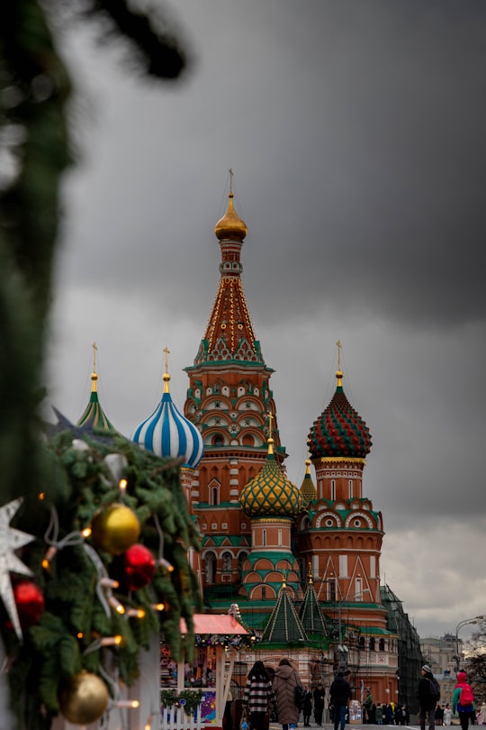 brown and green concrete building under white clouds during daytime in Saint Basil's Cathedral Russia