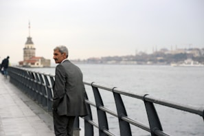 An international patient walking confidently along Istanbul’s scenic waterfront after treatment.