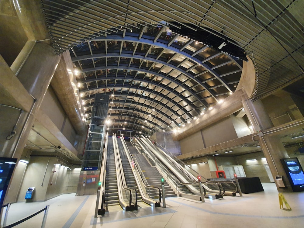 people walking on escalator inside building