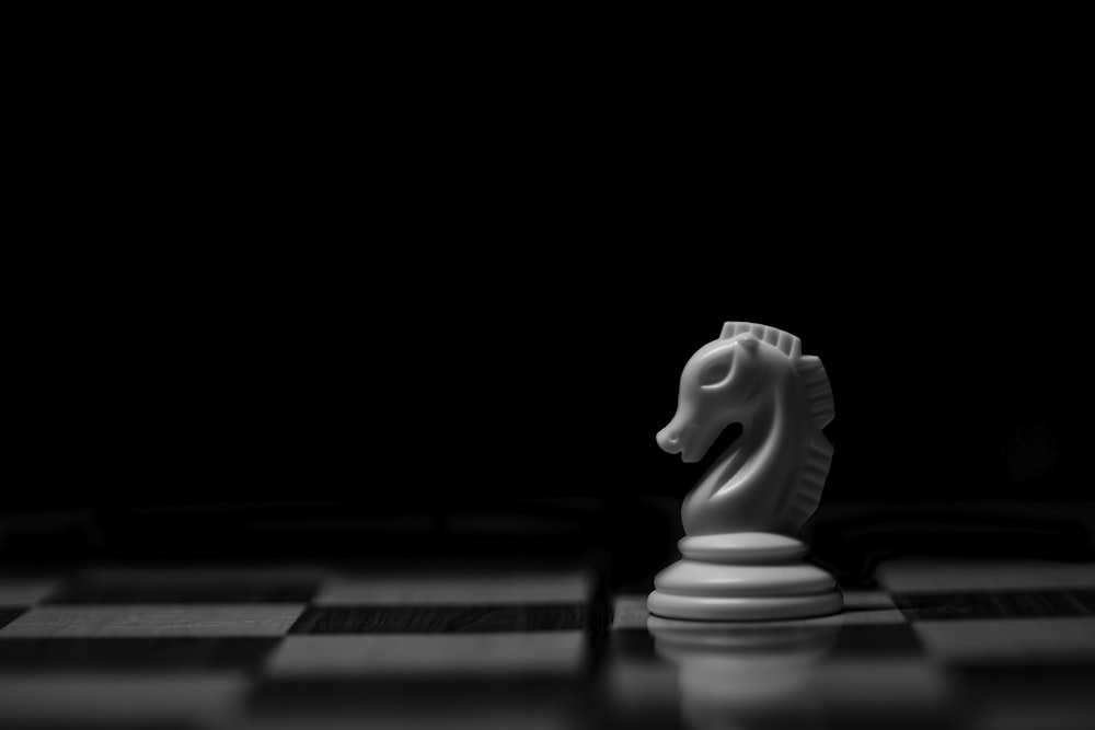 white ceramic animal figurine on black table