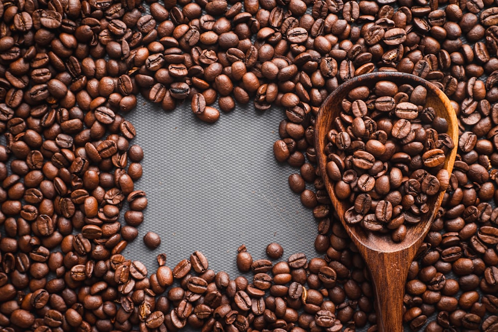 brown wooden spoon with coffee beans