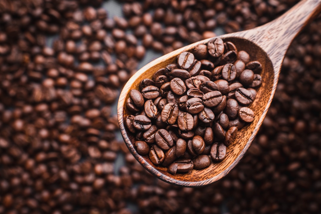 brown coffee beans on brown wooden bowl