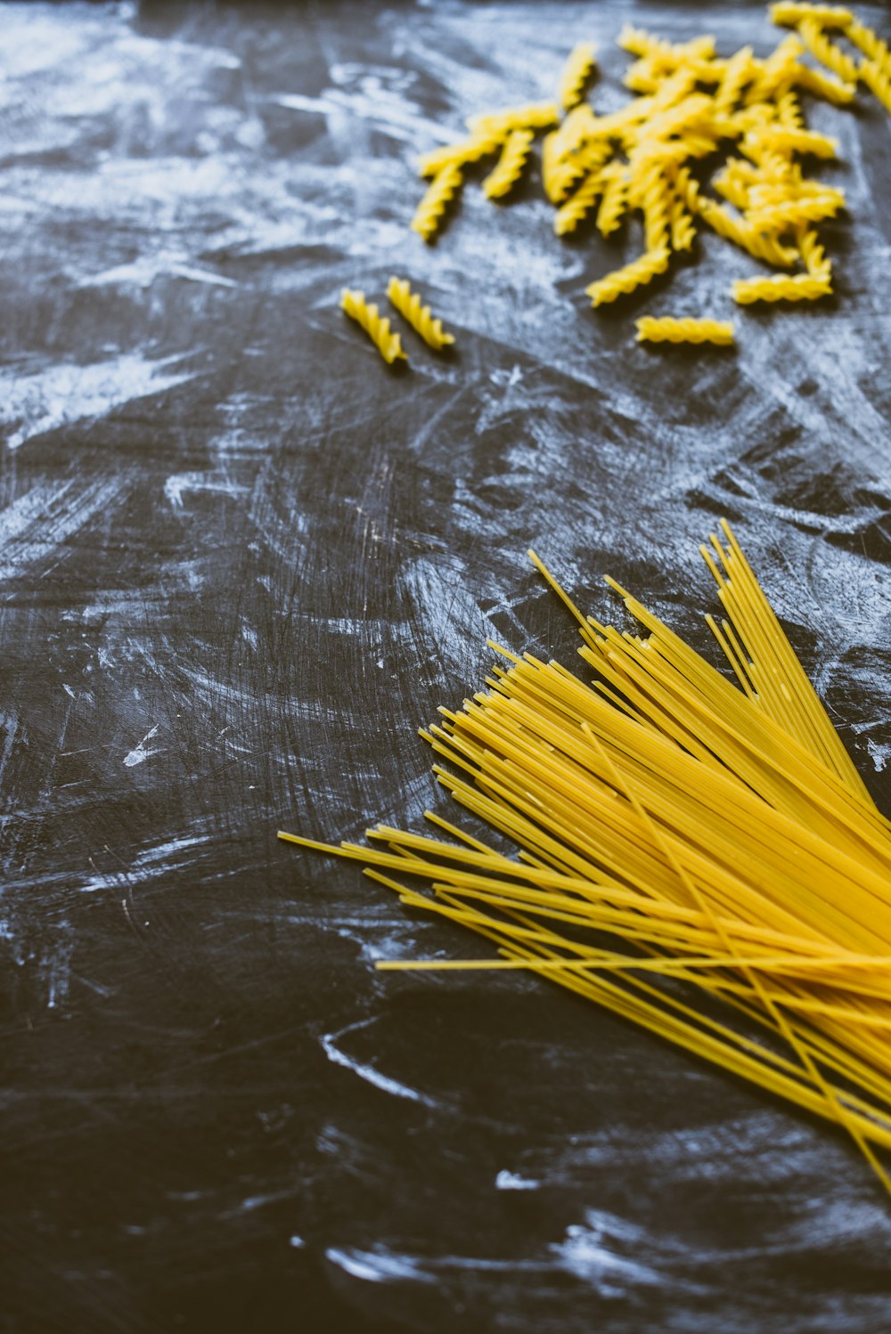 yellow pasta on black wooden table