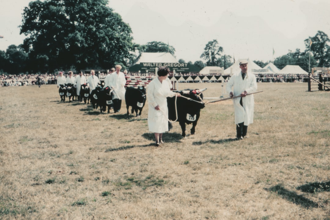 people in white robe standing on green grass field during daytime
