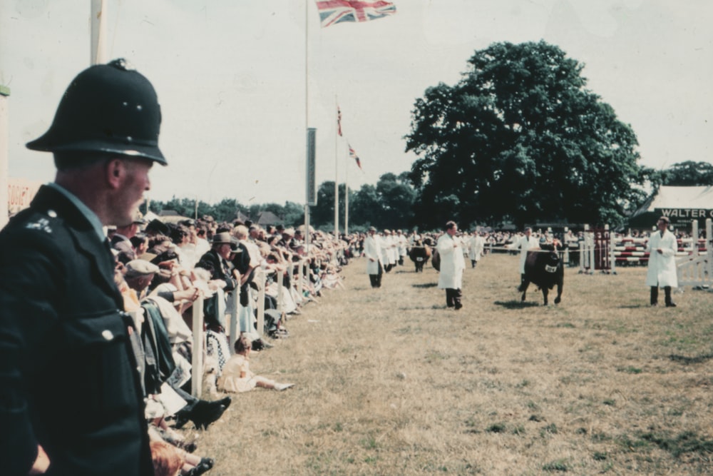 people in white uniform holding flags during daytime