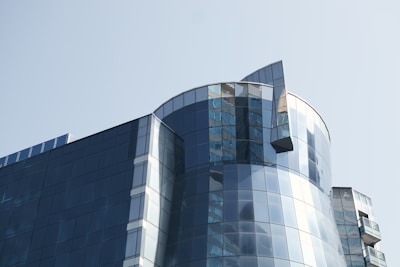 A modern architectural detail of a university research building under clear skies.