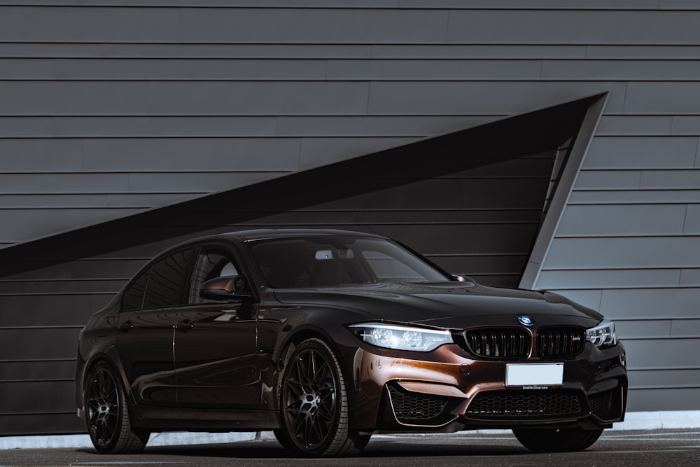 black audi a 4 coupe parked beside white wall