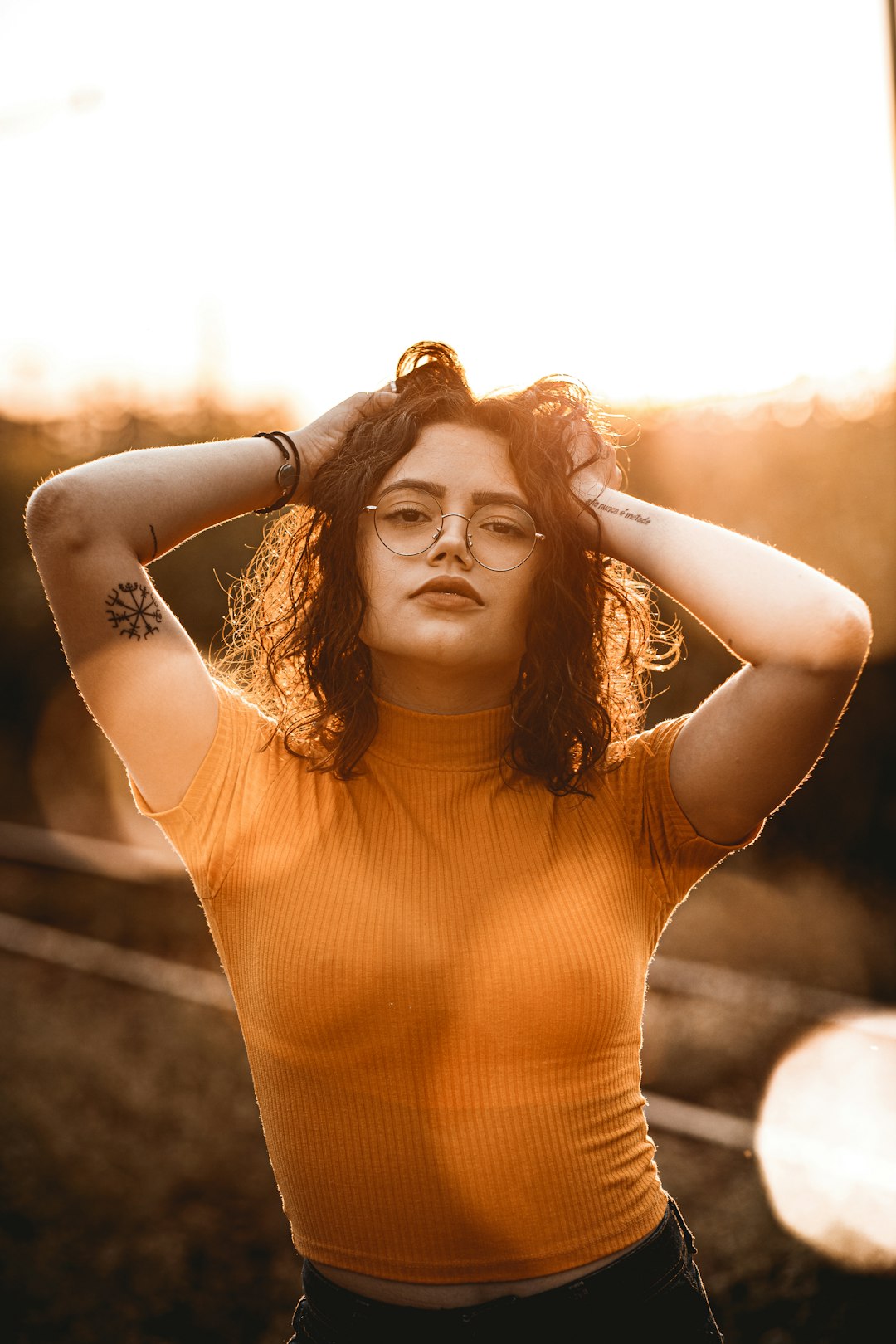 woman in orange tank top smiling