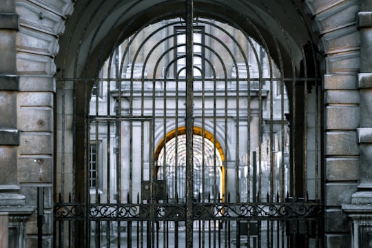 black metal gate with yellow and black arch in Cambridge United Kingdom