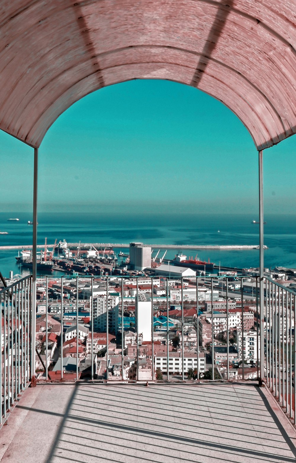 people walking on bridge over the sea during daytime