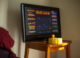 black flat screen tv on brown wooden table