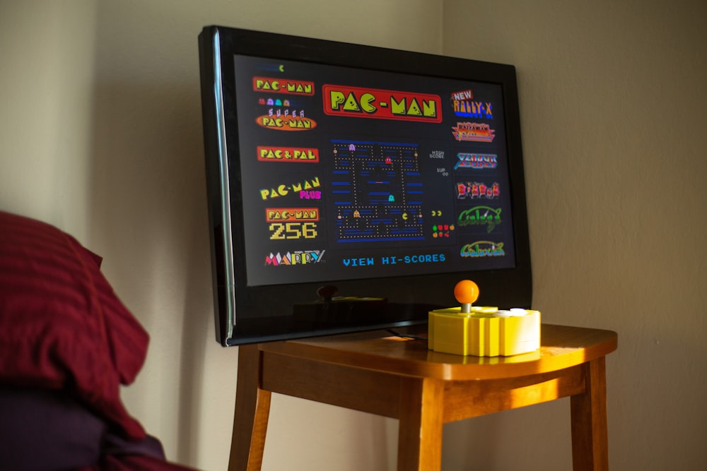 black flat screen tv on brown wooden table