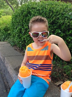 Children enjoying refreshing shaved ice on a sunny day.