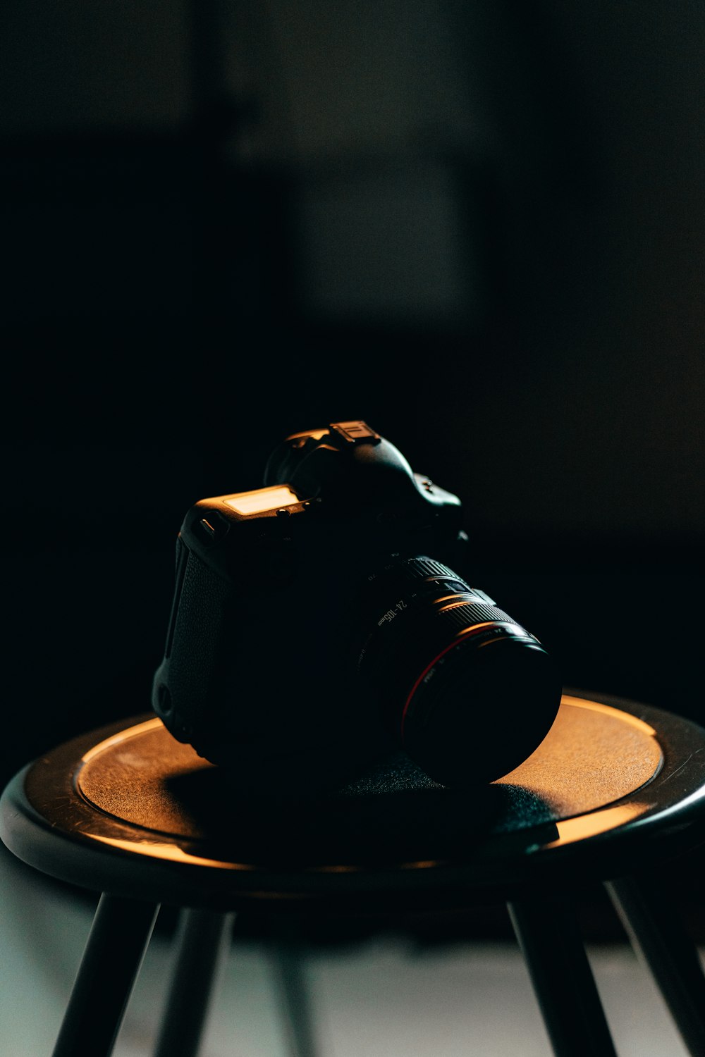 black dslr camera on brown round table