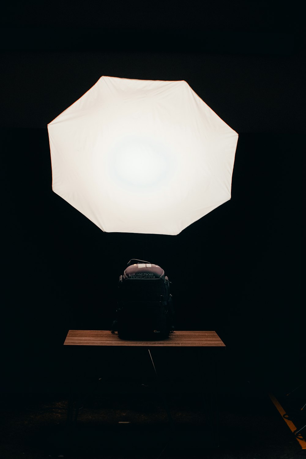 white light bulb on brown wooden table