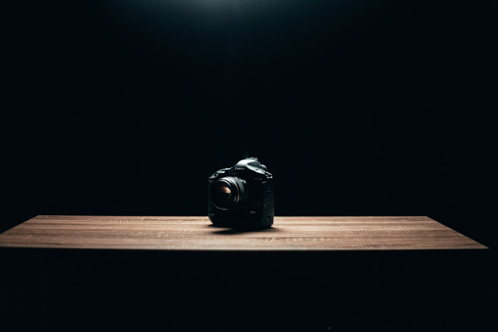 black camera on brown wooden table