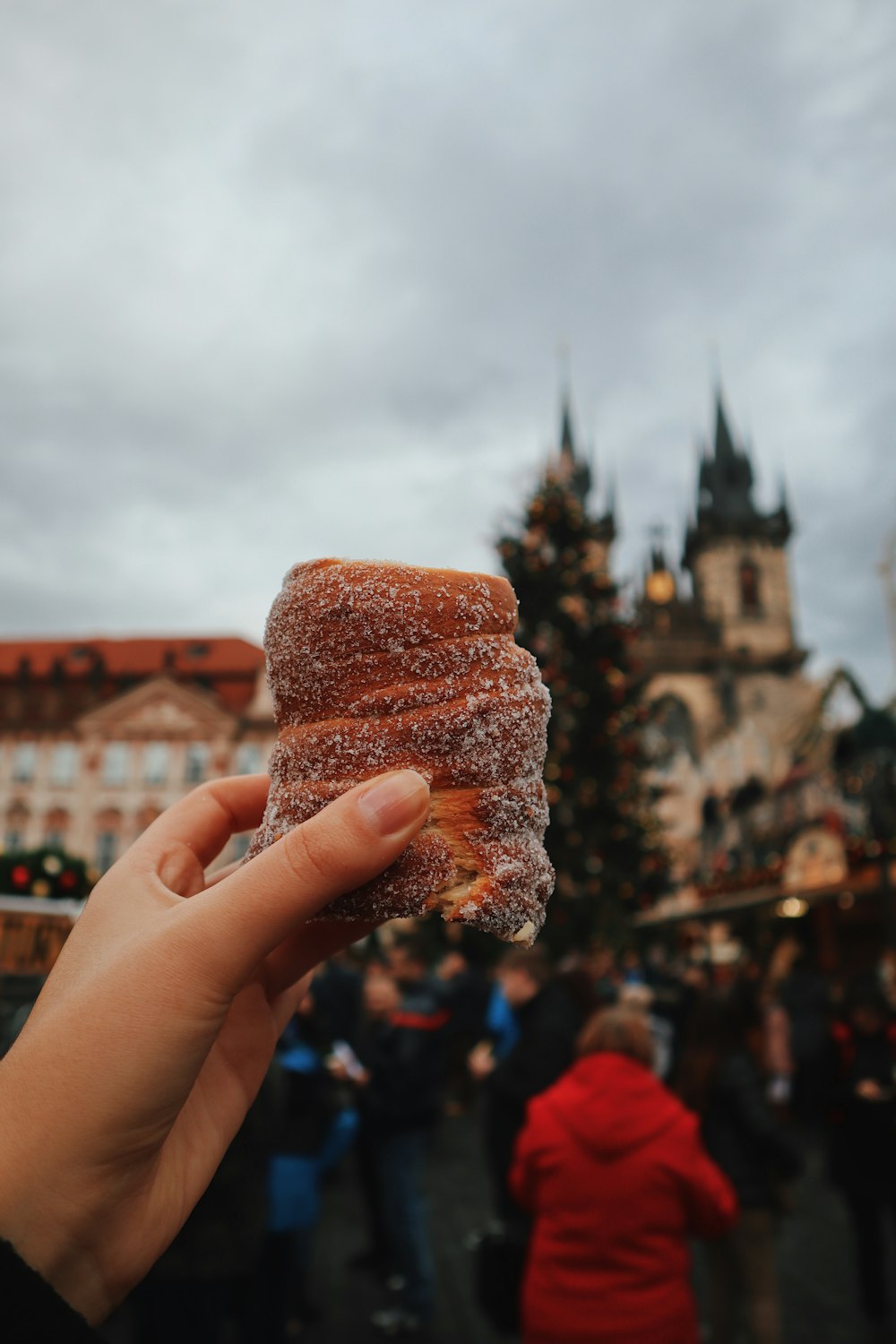 person holding brown bread with brown powder