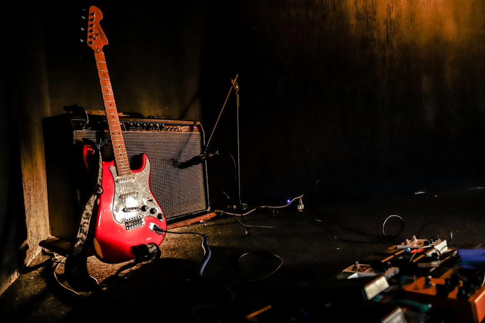 red and white stratocaster electric guitar