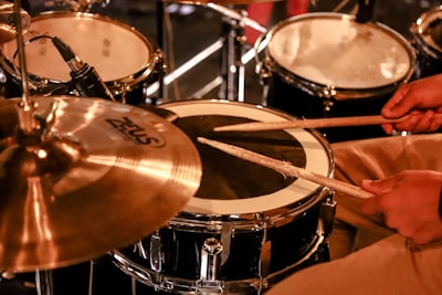 brown and black drum set drumstick teams background