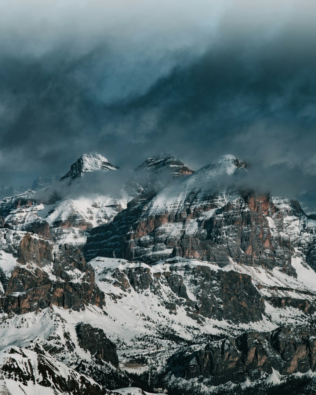 snow covered mountain under cloudy sky during daytime