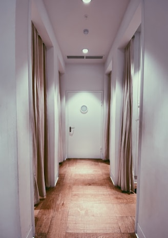 brown wooden parquet floor with white wall paint