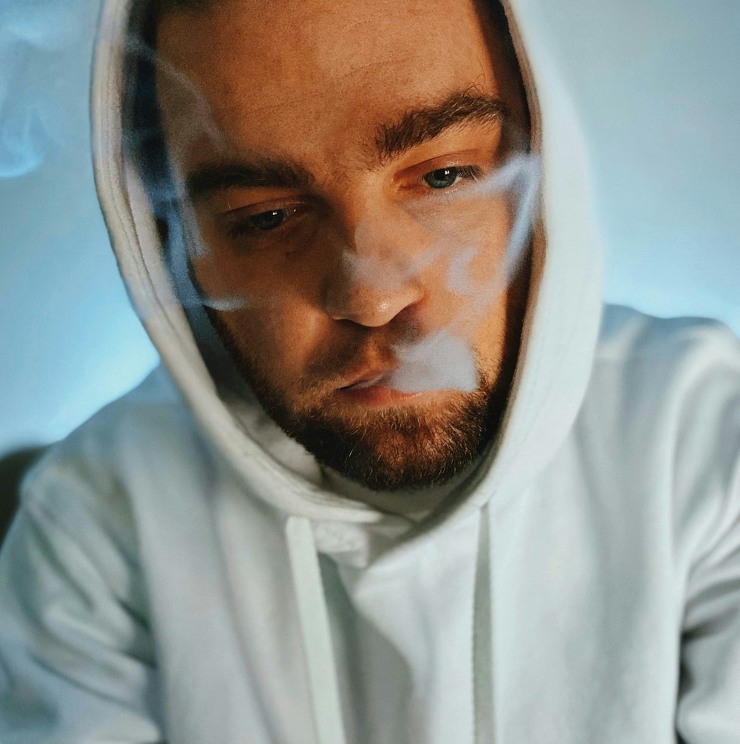 man in white hoodie taking selfie