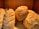 A group of diverse people enjoying freshly baked bread together.