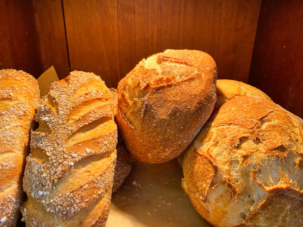 Fresh assortment of homemade breads on a rustic wooden table.