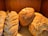 A group of diverse people enjoying freshly baked bread together.