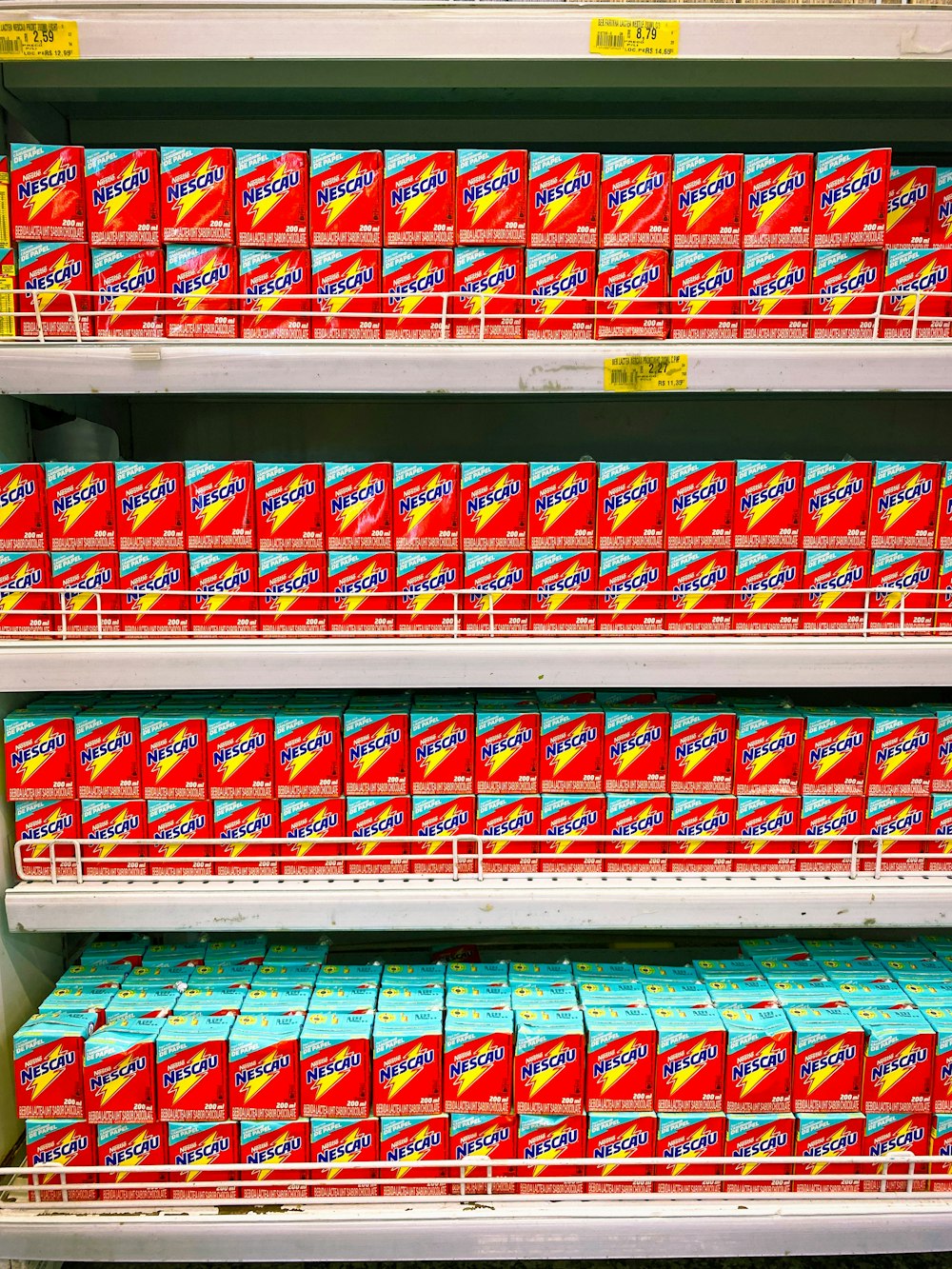 red and white plastic bottle on white shelf