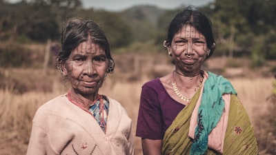 Portrait of two women of the Kandh tribe as they wait near well at the periphery of their village for their turn of collecting water for their house.