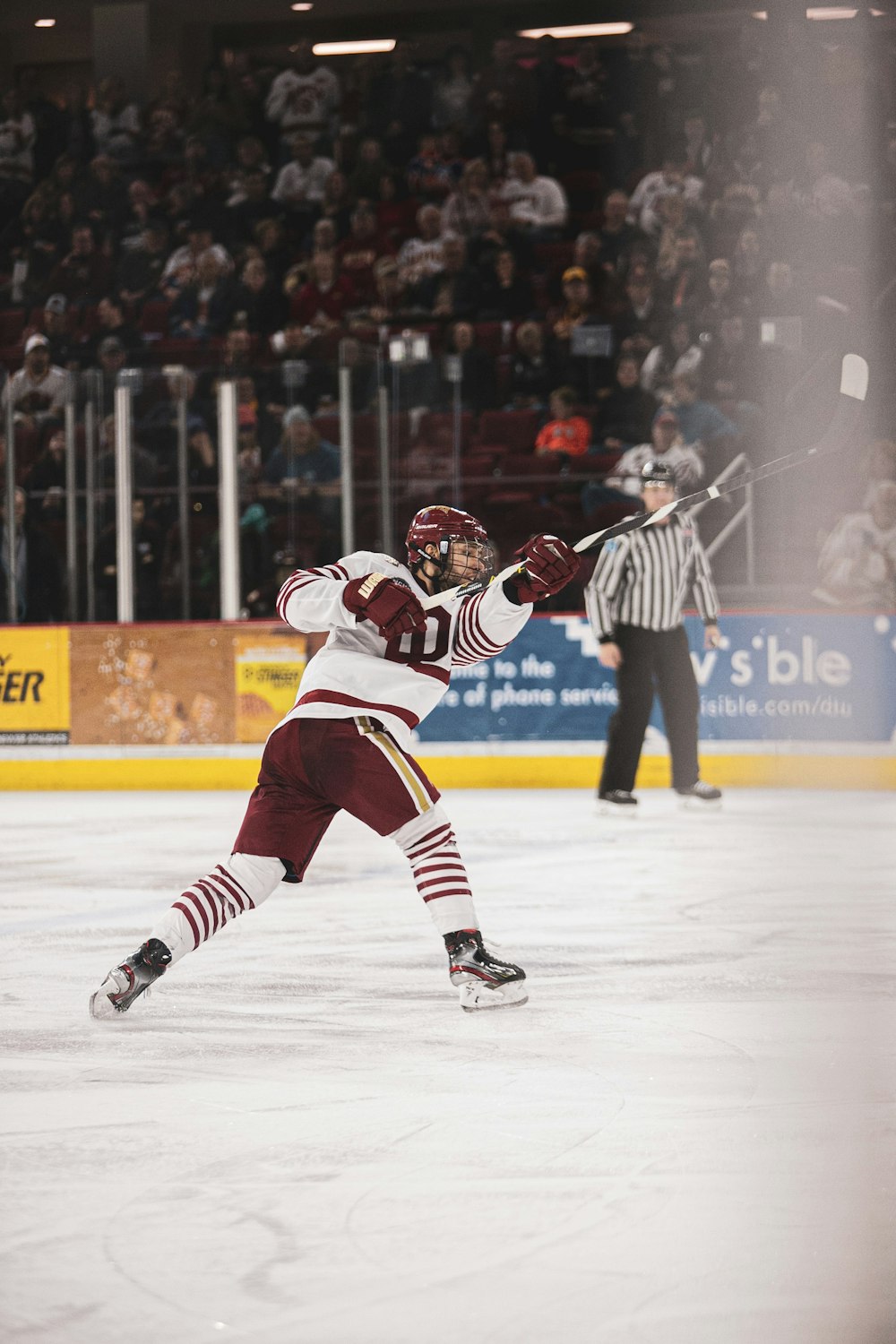 man in white and red jersey playing ice hockey