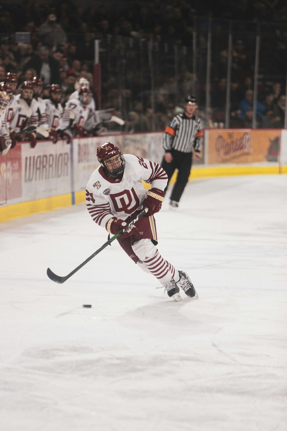 man in black and white ice hockey jersey playing hockey