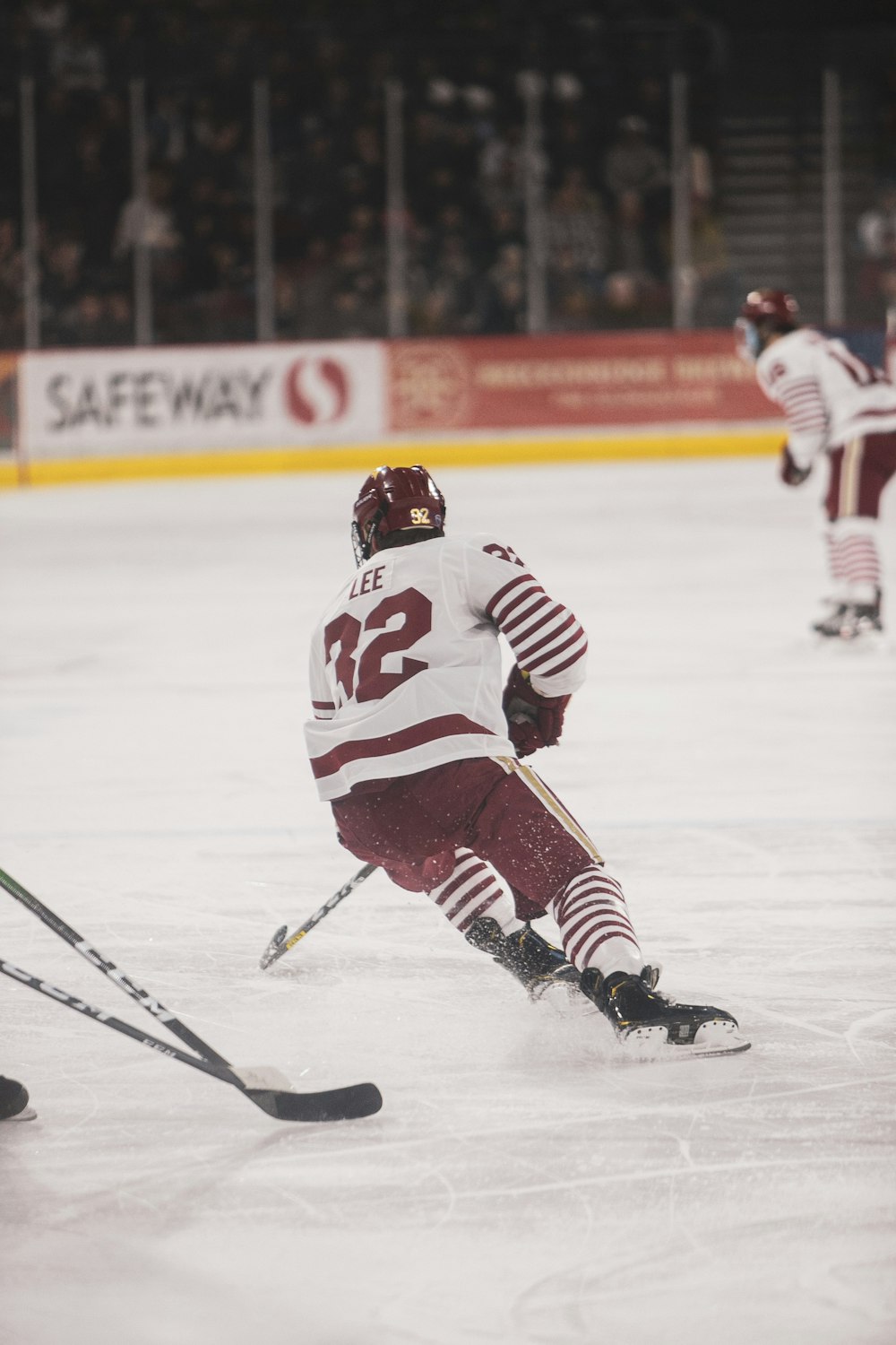 man in white ice hockey jersey playing hockey