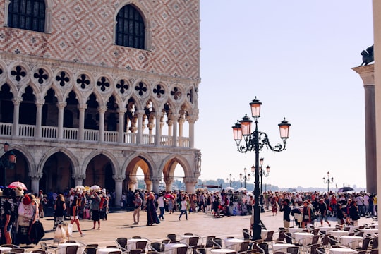 people walking on street near building during daytime in Doge's Palace Italy