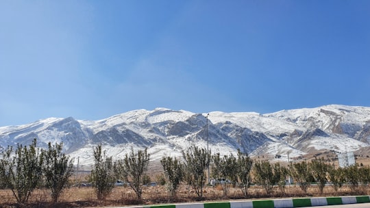 snow covered mountain under blue sky during daytime in Shiraz Iran