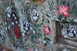 A vibrant mural combining human anatomy and flowing paint strokes symbolizing movement.