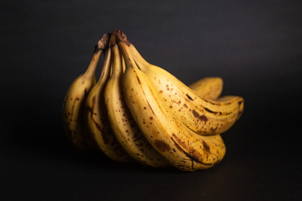 yellow banana fruit on black textile