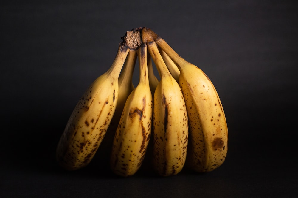 yellow banana fruit on blue textile