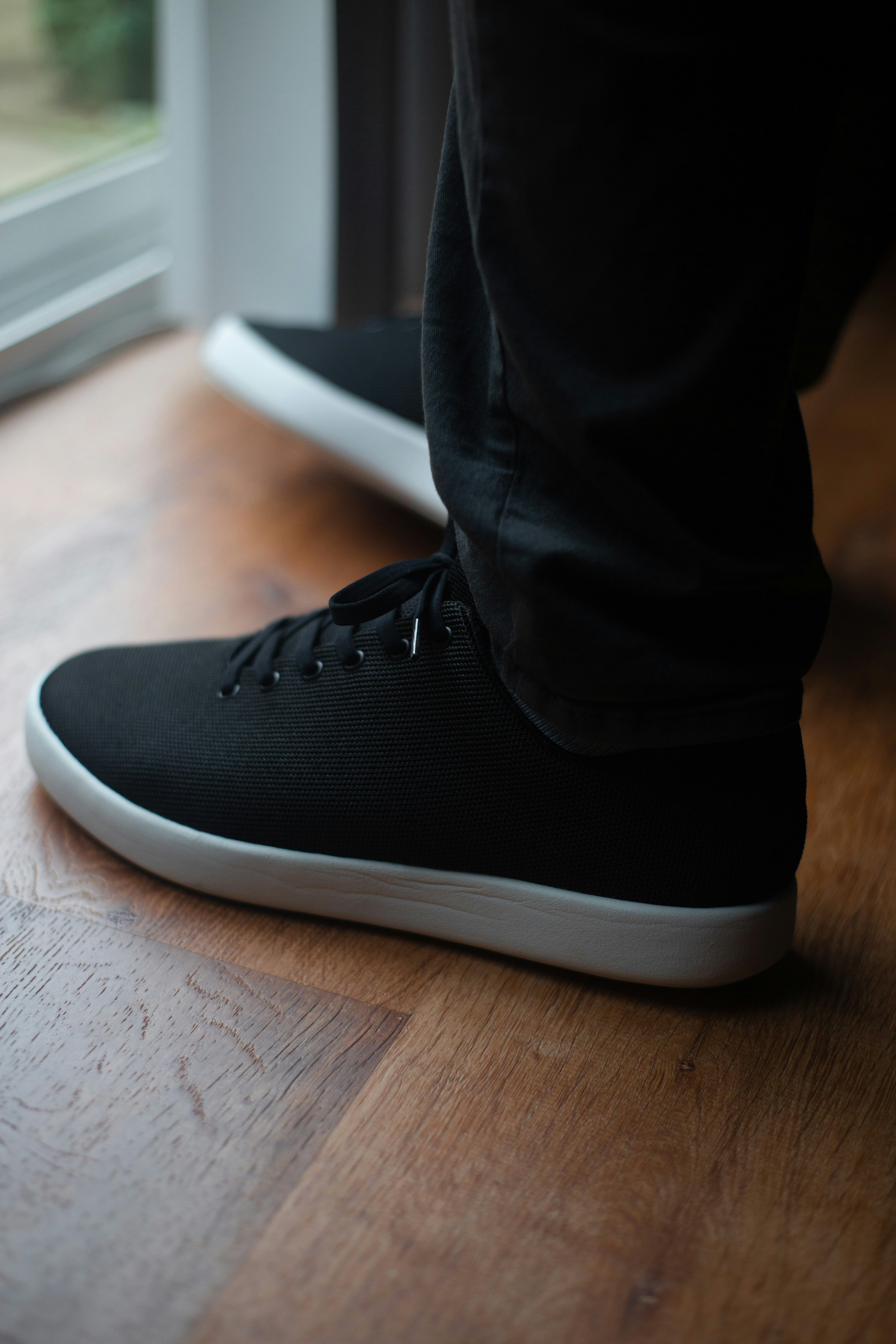 person wearing black and white nike high top sneakers