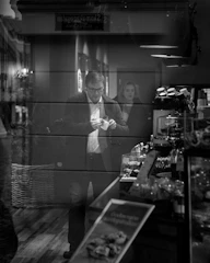 Photo of a consultant reviewing financial reports with a small business owner at a cozy Melbourne cafe.
