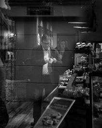 A candid photo of a man casually chatting with a woman at a cozy café in Stockholm, capturing a genuine moment of connection.