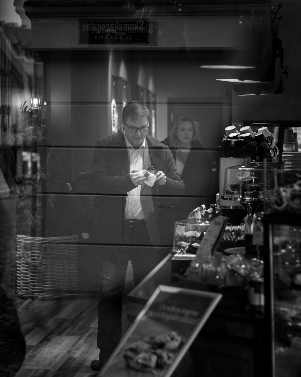 man in suit jacket standing in front of mirror