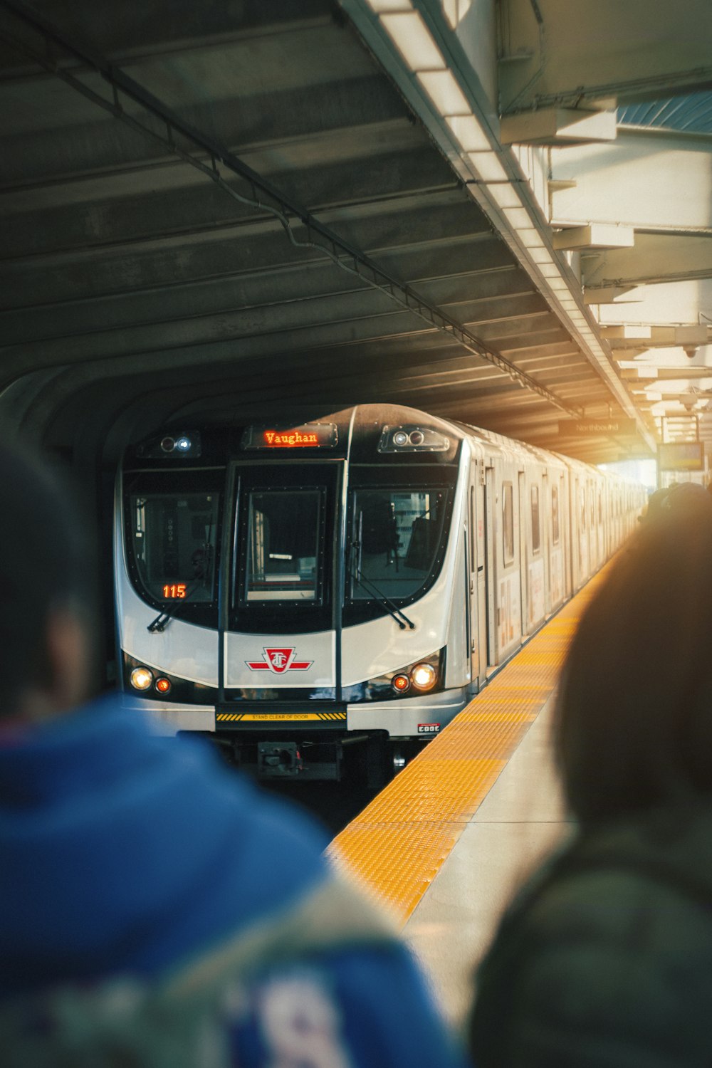 white and black train in a tunnel