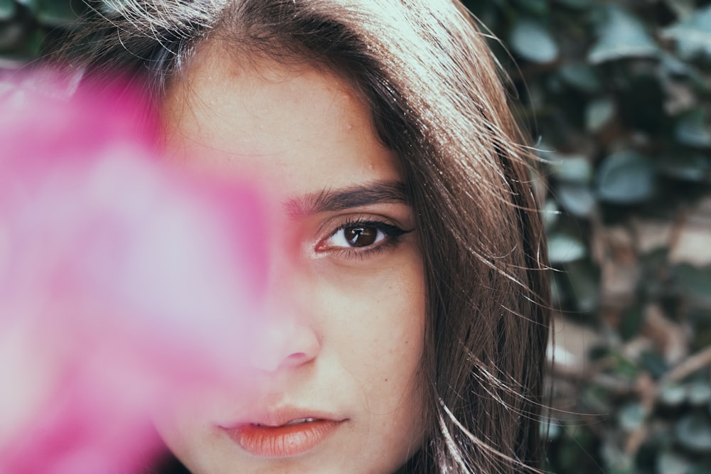 woman with brown hair and pink lipstick