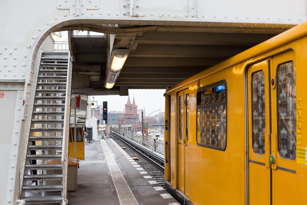 yellow and white train on train station during daytime